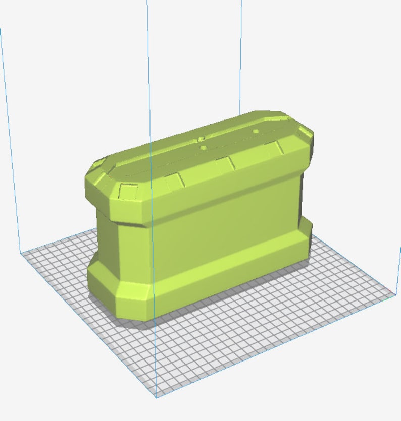 May include: A light green, rectangular container with a geometric design. The container has a series of rectangular shapes on the top and bottom. The object is sitting on a grid.