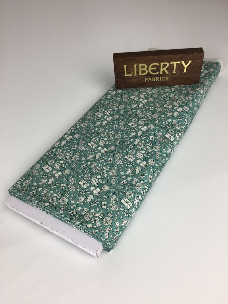 green Christmas fabric Festive cheer green cotton fabric from Liberty fabrics sold by the fat quarter and metre