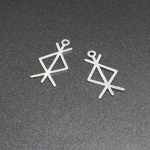 May include: Two silver charms in the shape of a geometric symbol with a loop at the top for attaching to a necklace or bracelet.