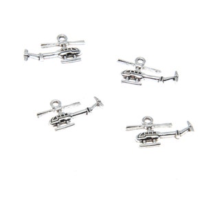 May include: Four silver helicopter charms with a detailed design. The charms have a loop at the top for attaching to jewellery or other crafts.