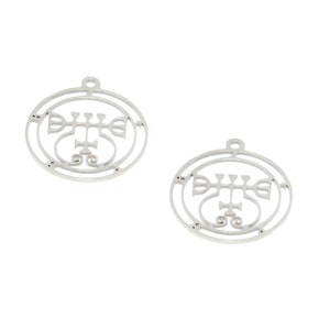 May include: Two silver pendants with a circular design. Each pendant features a stylized symbol within a double-lined circle, with a small loop at the top for hanging. The design is intricate and symmetrical.