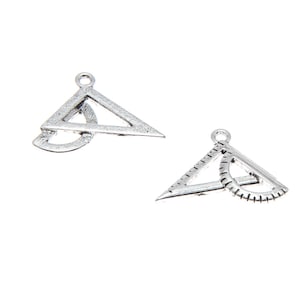 May include: Two silver-toned metal charms shaped like a protractor and triangle. The charms are layered on top of each other.