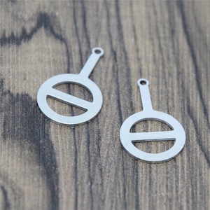 May include: Two silver metal charms with a circle design and a horizontal line across the center. The charms have a small loop at the top for attaching to jewelry or other crafts.