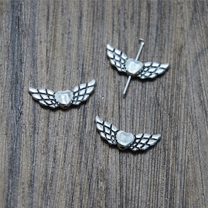 20 cuentas con dijes de alas de ángel en forma de corazón en tono plateado de 22 x 8 mm