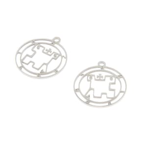 May include: Two silver metal charms in the shape of a circle with a stylized design inside. The design is a geometric pattern with a cross in the center.