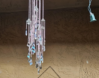 a tiny pink chained crystal wind chime