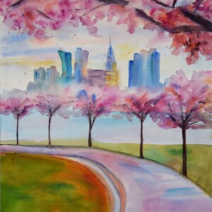 A watercolor painting of a city skyline with pink cherry blossoms in the foreground. The city is in the distance and the trees are in the foreground. A winding path leads to the city.
