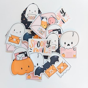 May include: A set of 10 spooky mail themed stickers featuring ghosts, pumpkins, bats, and skulls. The stickers are in various shades of pink, orange, and black. The stickers say "Spooky Mail" and "Trick or Treat".
