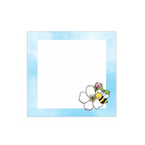 May include: A blue and white dotted notepad with a white flower and a yellow bee in the bottom right corner.