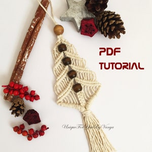 May include: A white macrame Christmas tree ornament with brown wooden beads and a tassel. The ornament is surrounded by cinnamon sticks, pine cones, and red berries. The text "PDF TUTORIAL" is written in red letters on a white background. The text "Unique For You By Vanya" is written in black letters on a white background.