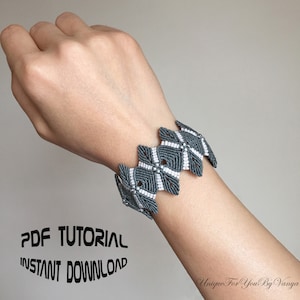 May include: A gray and white macrame bracelet with a geometric pattern. The bracelet is on a person's wrist. The image includes the text "PDF TUTORIAL INSTANT DOWNLOAD".