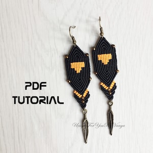 May include: A pair of black and gold feather earrings with a geometric pattern. The earrings are made with macrame and have a feather charm hanging from the bottom. The earrings are on a white wooden background. PDF TUTORIAL