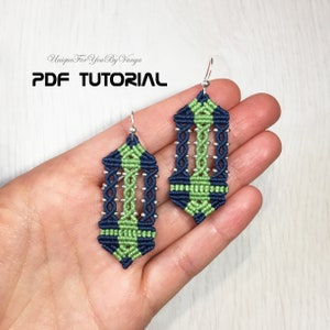 May include: A pair of green and blue macrame earrings with silver beads and a silver hook. The earrings are in the shape of a long, narrow rectangle with a pointed bottom. The text "PDF TUTORIAL" is visible at the top of the image.