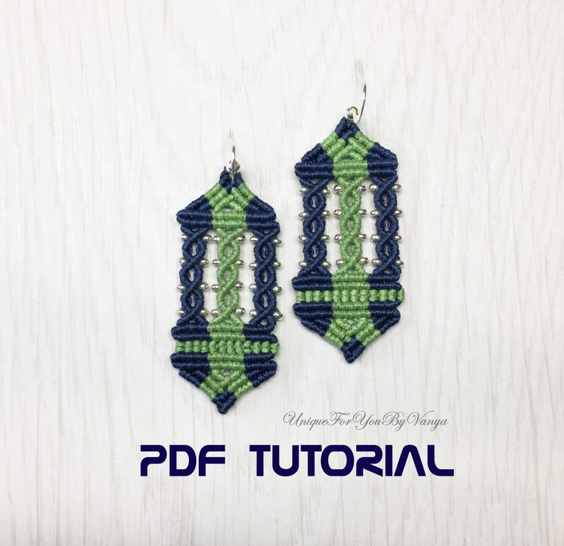 May include: A pair of green and blue macrame earrings with silver beads. The earrings are in the shape of a teardrop and have a geometric pattern. The earrings are hanging from silver hooks. The image includes the text "PDF TUTORIAL".