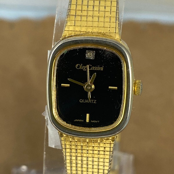 Vintage Oleg Cassini Dress Quartz Watch Black Face Gold Hands small diamond at 12