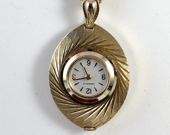 Vintage Caravelle 7 Jewel Gold Tone Pendant Watch in Oval Shape that has beed Brocaded and Diamond Cut Front Design Mechanical Hand Wind