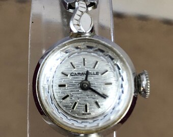 Vintage Caravelle 7 Jewel Silver Tone Watch in Round Shape Mechanical Hand Wind mesh strap 6.25 inches in length 5/8 inch case diameter