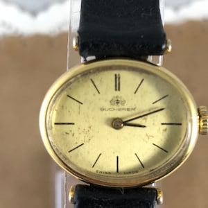 Vintage Bucherer Ladies Watch: 18K Gold Plated, Oval Black Strap