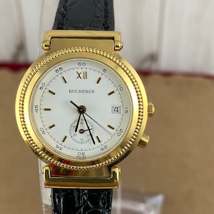 Vintage 1990's Bucherer Ladies Quartz Wrist Watch with 30 Minute Clock sub dial Gold Plated, Sculpured Coin Edge Bezel Black Leather Strap