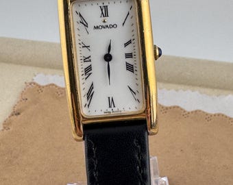 Vintage Movado Gold Tankl z cyframi rzymskimi, koperta platerowana 18-karatowym złotem, czarny pasek, szafirowa koronka