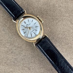 Vintage Bucherer 17 Jewel Swiss Made Watch with Silver and Gold Bezel meticulously enhanced with Machined Brocading and a Mineral Crystal