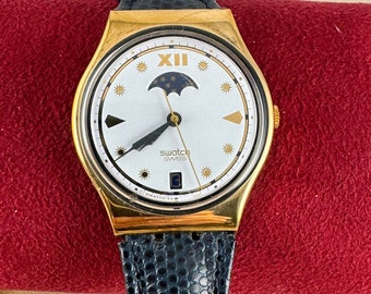 Rare Vintage New in Box Swatch Watch Moon Phase, Gold Plated Front Black Plastic Reverse , Navy Blue original 8.5 Inch Strap,