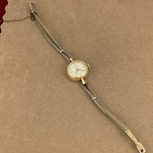 Movado Vintage Watch early 1950's late 1940's Hand Wind,  Solid 14 Karat Gold Case runs keeps time 10K Gold Filled Cord Band
