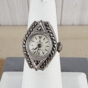 Vintage Marcasite Ring Bucherer Watch Swiss 800 Silver is 5.25 sized. Case is 3/4 by 1/2-inch-wide Diamond or Marquise Ring Shape