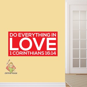 May include: A red rectangular sign with the words "DO EVERYTHING IN LOVE" in white, with "1 CORINTHIANS 16:14" below. A cartoon character with a paintbrush is in the lower left corner, with the text "CERTIFIED DESIGN". The sign is on a yellow wall.