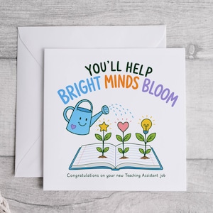 May include: A square greeting card with a white envelope featuring a blue watering can, an open book with three plants growing from it, and the text "YOU'LL HELP BRIGHT MINDS BLOOM" and "Congratulations on your new Teaching Assistant job".