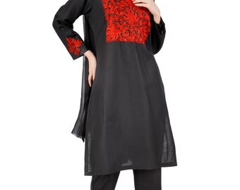 May include: Black embroidered tunic and pants set. The tunic features a red floral design on the chest and sleeves. The pants have matching floral embroidery at the ankles. A black scarf completes the outfit.