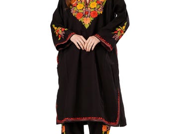 May include: Black embroidered tunic and pants set. The tunic features a V-neck and floral embroidery in red, orange, and yellow. The pants have matching floral embroidery. The outfit is a traditional style.