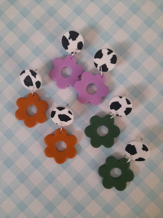 Polymer clay daisy dangle earrings with cow print stud