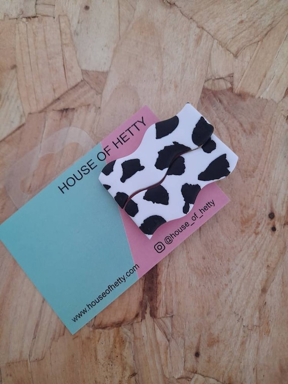 Cow print hair barrettes made from polymer clay. Set of 2
