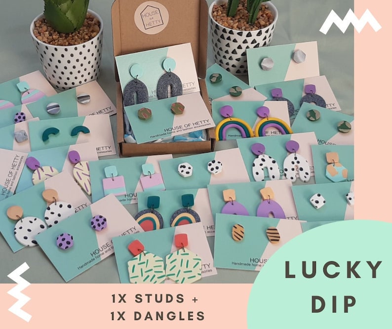 May include: A selection of colorful handmade polymer clay earrings in a variety of shapes and designs. The earrings are displayed on cards with the text "House of Hetty" and "Lucky Dip".