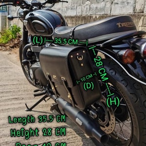 May include: Black leather motorcycle saddlebag with a buckle closure. The bag measures 35.5 inches long, 28 inches high, and 10 inches deep.