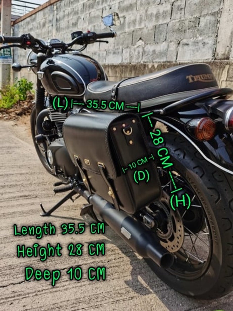 May include: Black leather motorcycle saddlebag with a buckle closure. The bag measures 35.5 inches long, 28 inches high, and 10 inches deep.