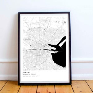 May include: Black and white map print of Dublin, Republic of Ireland, in a black frame. The map shows the city's streets and waterways, with the coastline highlighted in black.