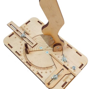 May include: A light-coloured wooden manual cutting tool featuring a vertical handle with a metal blade, a circular protractor base with engraved degree markings, and two adjustable sliding guides secured by metal wing nuts and screws.