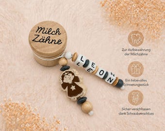 May include: A wooden keepsake box with the words "Milch Zähne" printed on the lid. Attached is a beaded charm spelling "LEON" and a wooden angel figure. The box is designed for storing baby teeth.