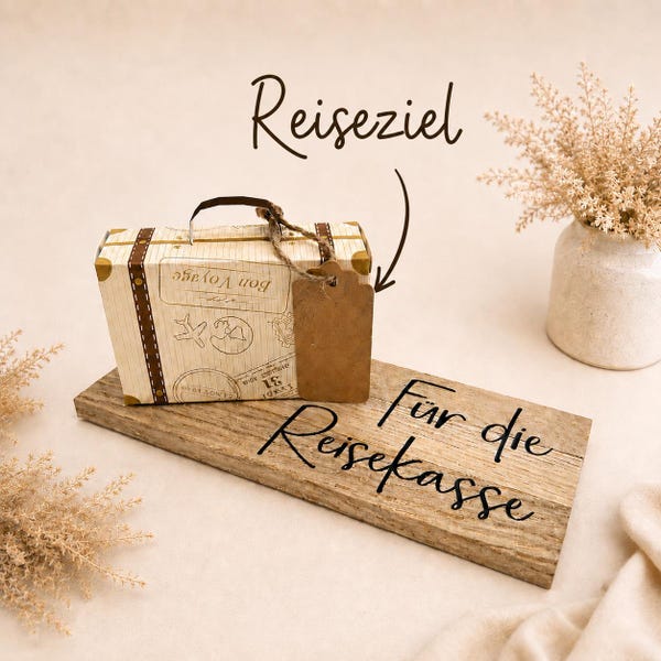 Travel money gift box made of paper on an oak wood board, money gift for travel with suitcase and personalized luggage tag