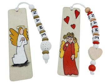 May include: Two wooden bookmarks with angel illustrations. One bookmark features a white angel with gold wings and a halo, and the other features a red angel with gold wings. Both bookmarks have a beaded tassel with the word "NAME" spelled out in white letters.