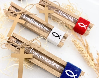 May include: Three wooden boxes with glass tubes containing small items. Each box has a different inscription: "Communion", "Confirmation", and "Firmung". The boxes are decorated with a small cross and a fish symbol.