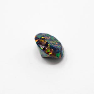 May include: A faceted, oval-shaped black opal gemstone. The opal displays a vibrant play-of-color, with flashes of green, orange, and yellow against a dark background. The gemstone is set against a white background.