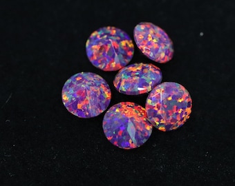 May include: Six round, faceted gemstones with a vibrant, multicolored pattern of purple, orange, and green. The gemstones are set against a black background, highlighting their brilliance and color variations. These gemstones would be ideal for jewelry making.