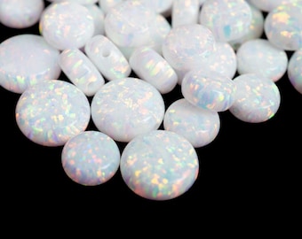 May include: A collection of white opal gemstones with iridescent flashes of color. The opals are in various shapes, including round and cylindrical, against a black background. The text "THEOPALDEALER" is at the bottom.
