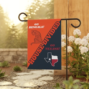 May include: A red and blue garden flag with the text "House Divided" and the words "Go Bengals!" and "Go Texans!" on opposite sides. The flag also features a tiger and the outline of the state of Texas.