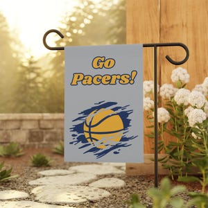 May include: A gray garden flag with the text "Go Pacers!" in yellow and a basketball with a blue and white ripped background.