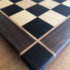 Peruvian Walnut Chessboard: Peruvian Walnut and Maple squares, Black Walnut borders and Wengewood corners.  Squared off edges, smoooth.....