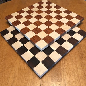 Top board is Jatoba Cherry with Hard Maple.  The reddish tones will darker over time.
The bottom board is Black Walnut and Hard Maple.  Tone intensity will vary.